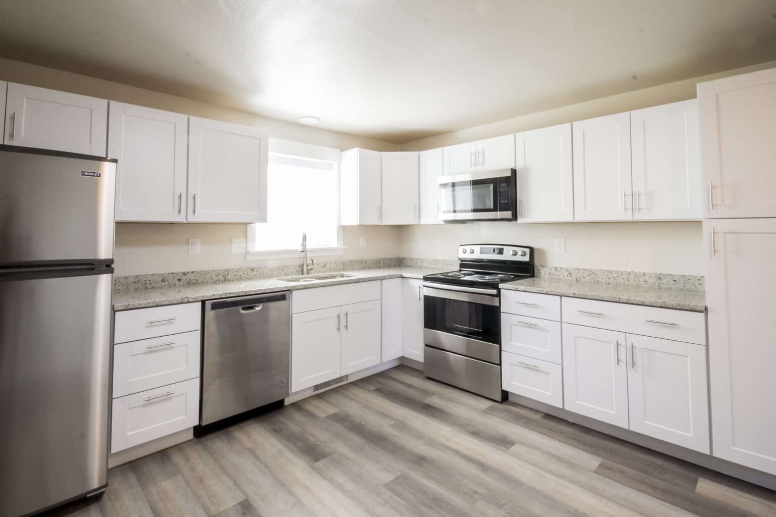 Full kitchen with granite counters and stainless appliances in a short-term furnished Twin Cedar rental in Vernal, Utah