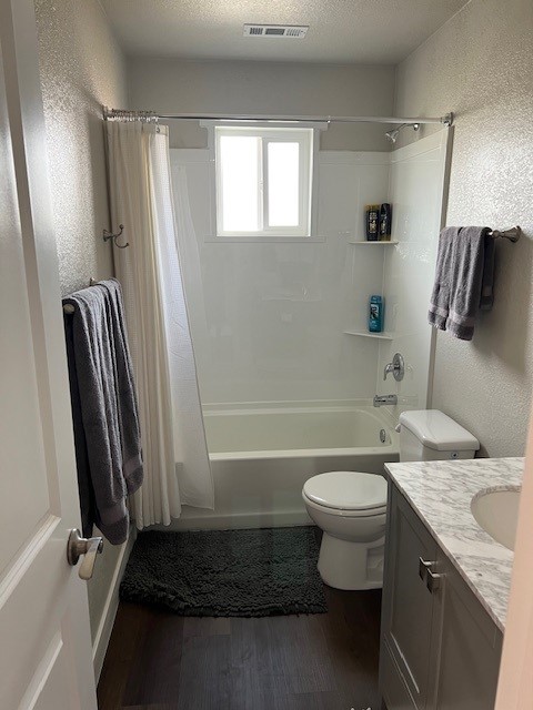 Full bathroom with tub, shower, toilet, and vanity
