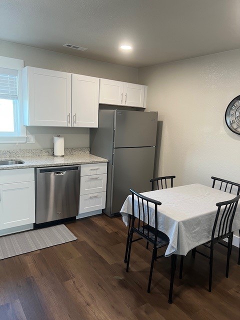 Kitchen with dining table, chairs, and wall clock
