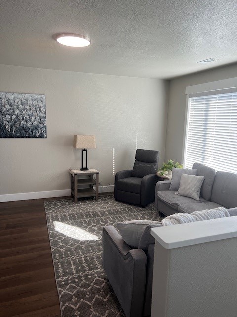 Living room with reclining sofa, accent chair, and floor lamp
